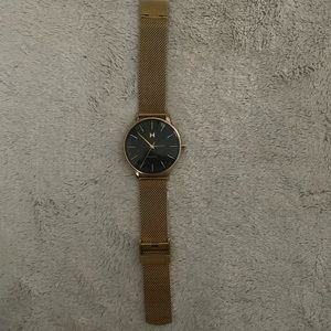 Women’s yellow gold with black dial MVMT watch